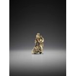 A RARE IVORY NETSUKE OF A CHINESE SAGE WITH SHISHI