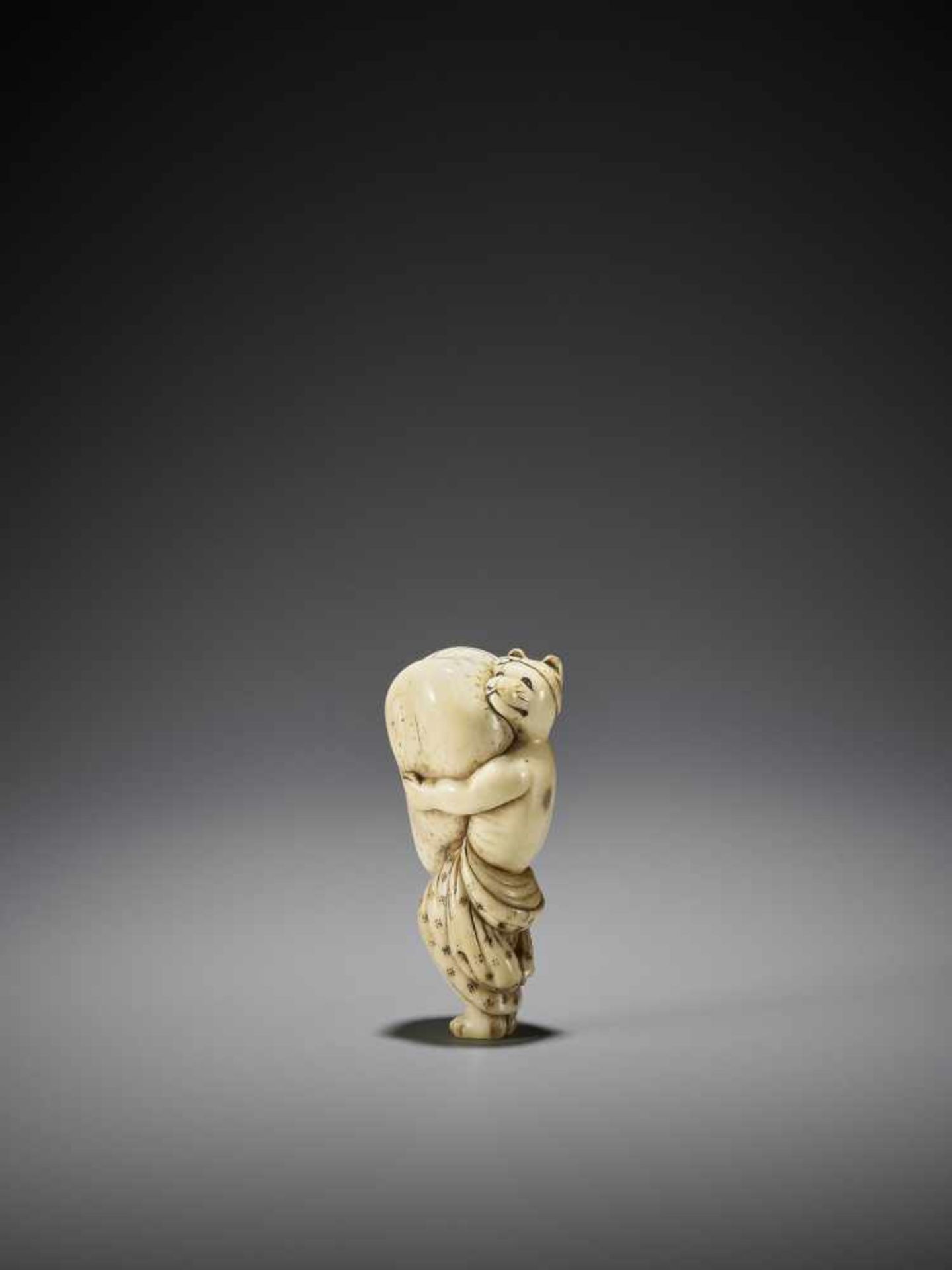 A LARGE AND AMUSING IVORY NETSUKE OF A TANUKI WITH HUGE SCROTUM - Image 3 of 9