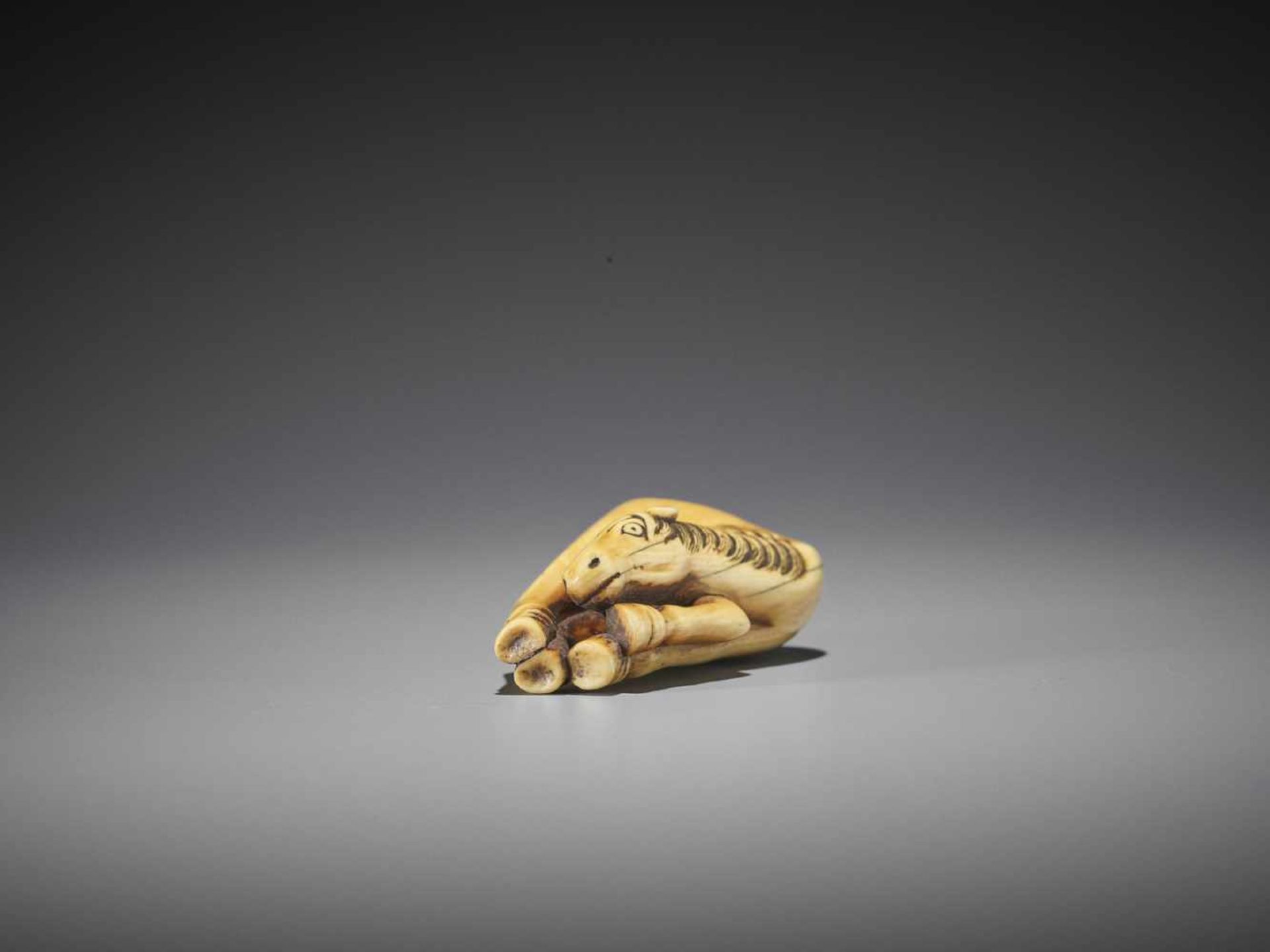 A FINE AND LARGE IVORY NETSUKE OF A GRAZING HORSE - Image 9 of 9