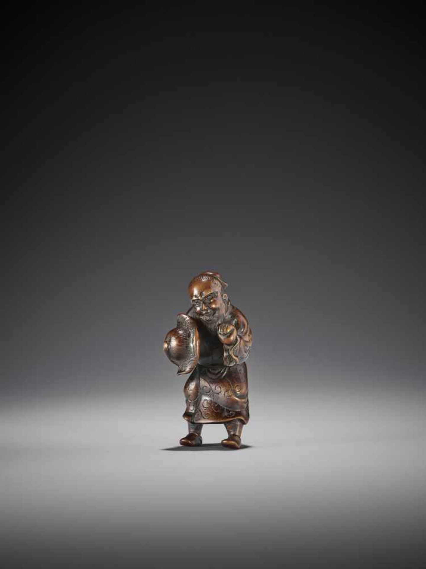 A RARE WOOD NETSUKE OF A CHINESE MAN