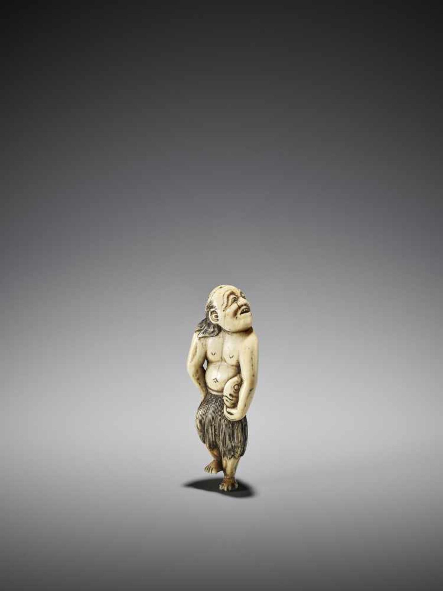 A VERY RARE IVORY NETSUKE OF A FISHERMAN