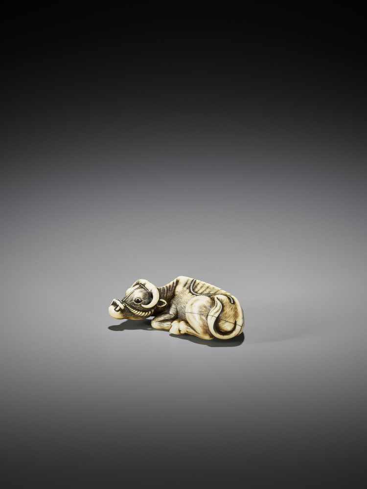 TOMOTADA: AN IVORY NETSUKE OF A RECUMBENT OX - Image 2 of 10