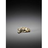 TOMOTADA: AN IVORY NETSUKE OF A RECUMBENT OX