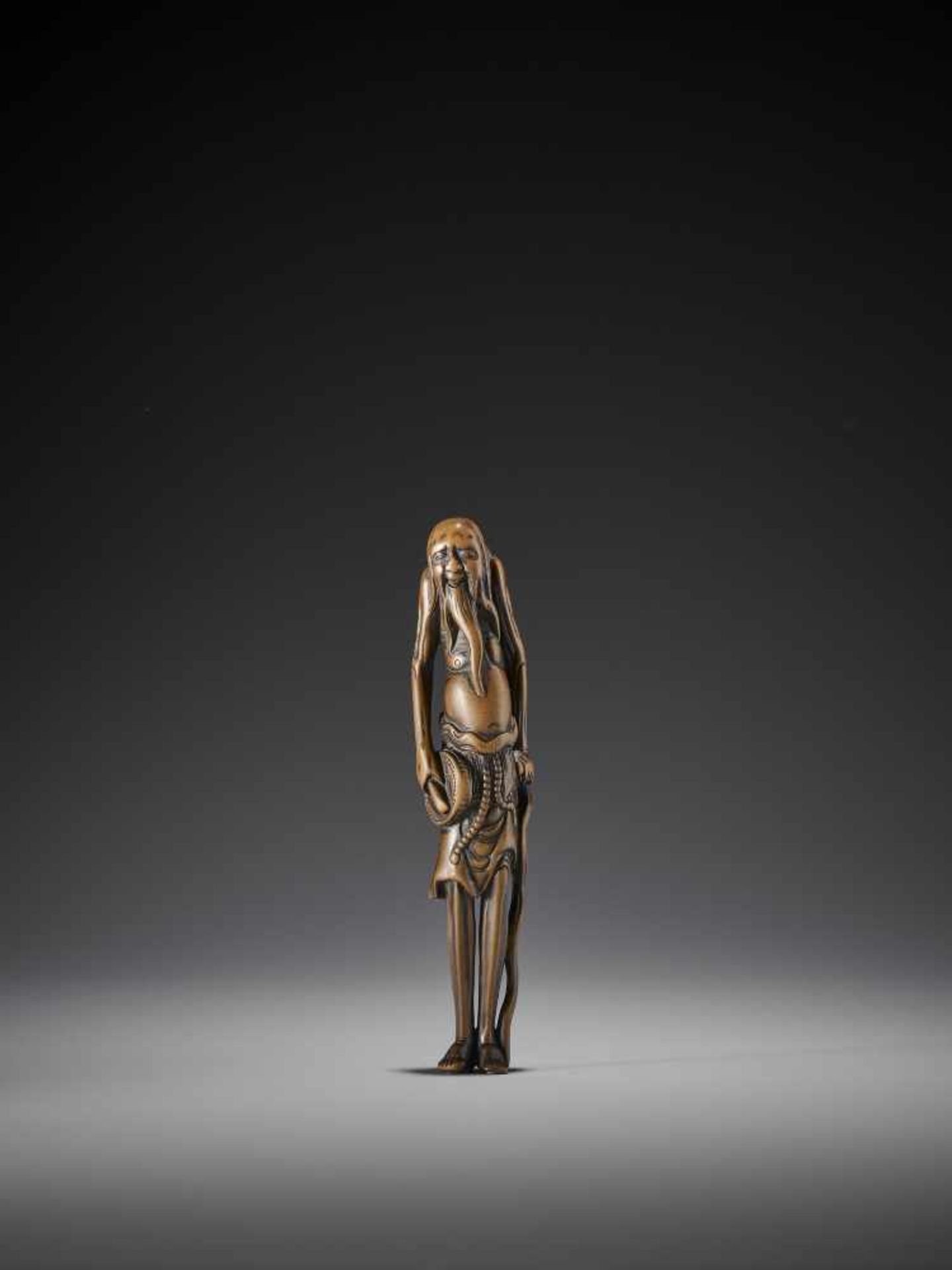 AN EXCELLENT TALL WOOD NETSUKE OF A SOUTH SEA ISLANDER