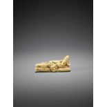 AN EARLY IVORY NETSUKE OF A RECLINING BUGAKU DANCER