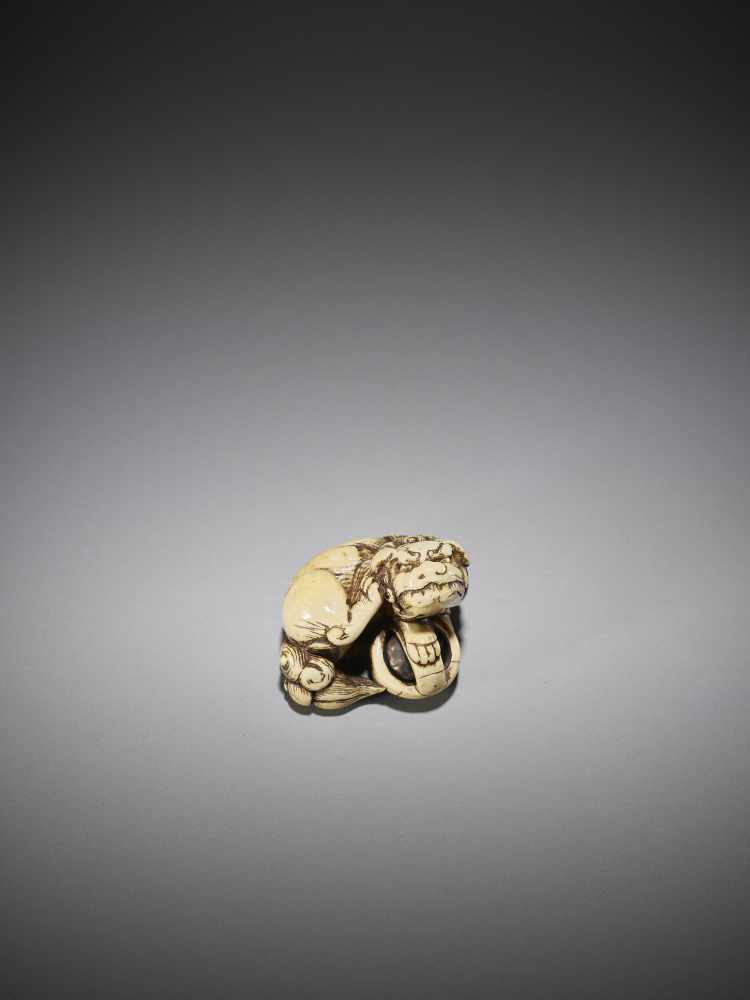 AN IVORY NETSUKE OF A SHISHI WITH BALL - Image 3 of 9