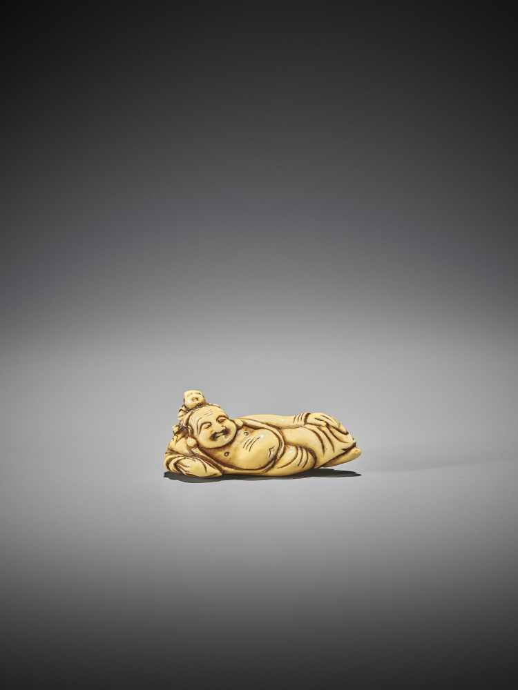 AN EARLY IVORY NETSUKE OF HOTEI WITH KARAKO