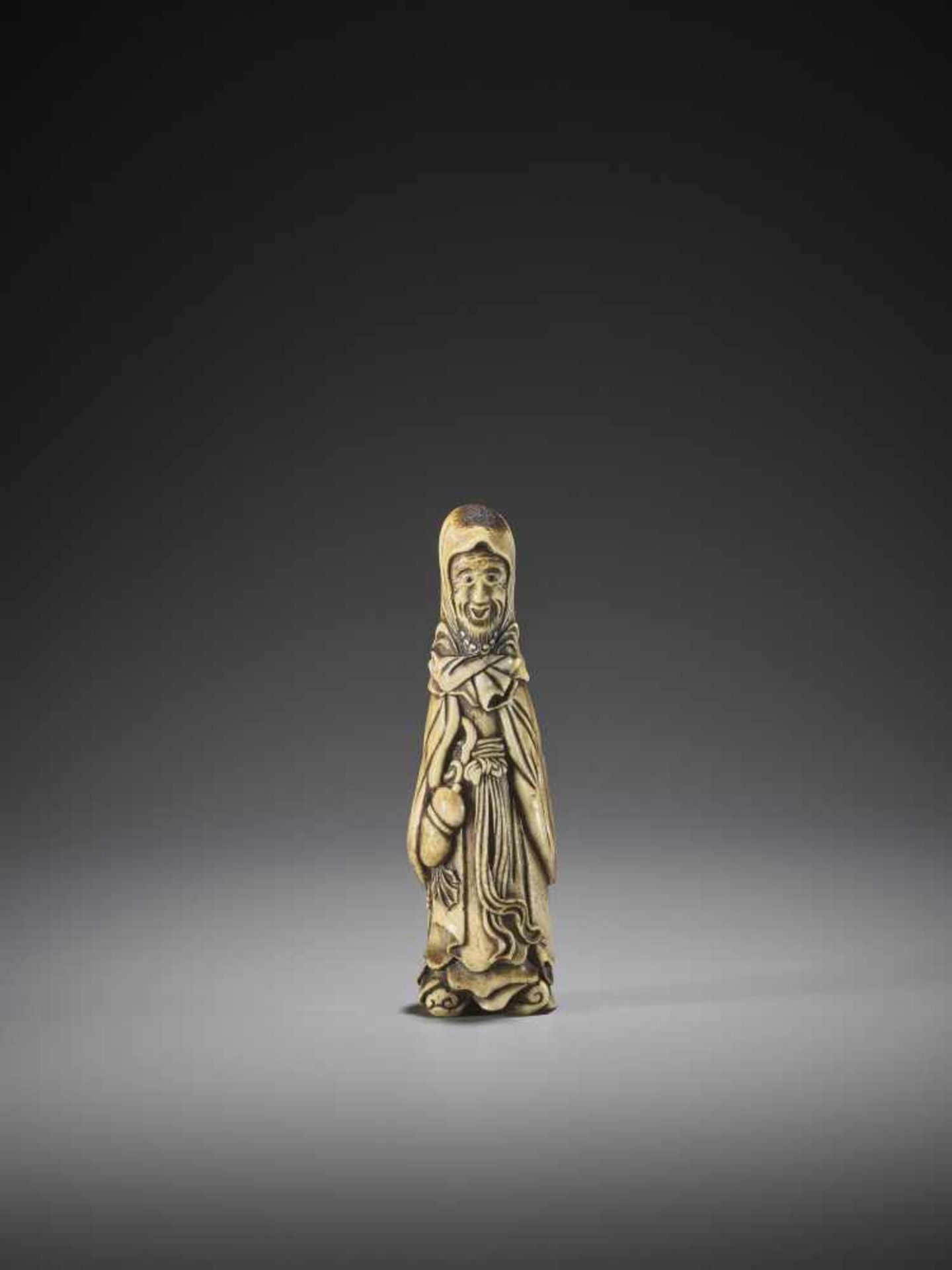 A SUPERB AND UNUSUAL STAG ANTLER NETSUKE OF A FOREIGNER