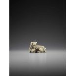 TOMOTADA: A SUPERB IVORY NETSUKE OF A DOG WITH HAMAGURI CLAM