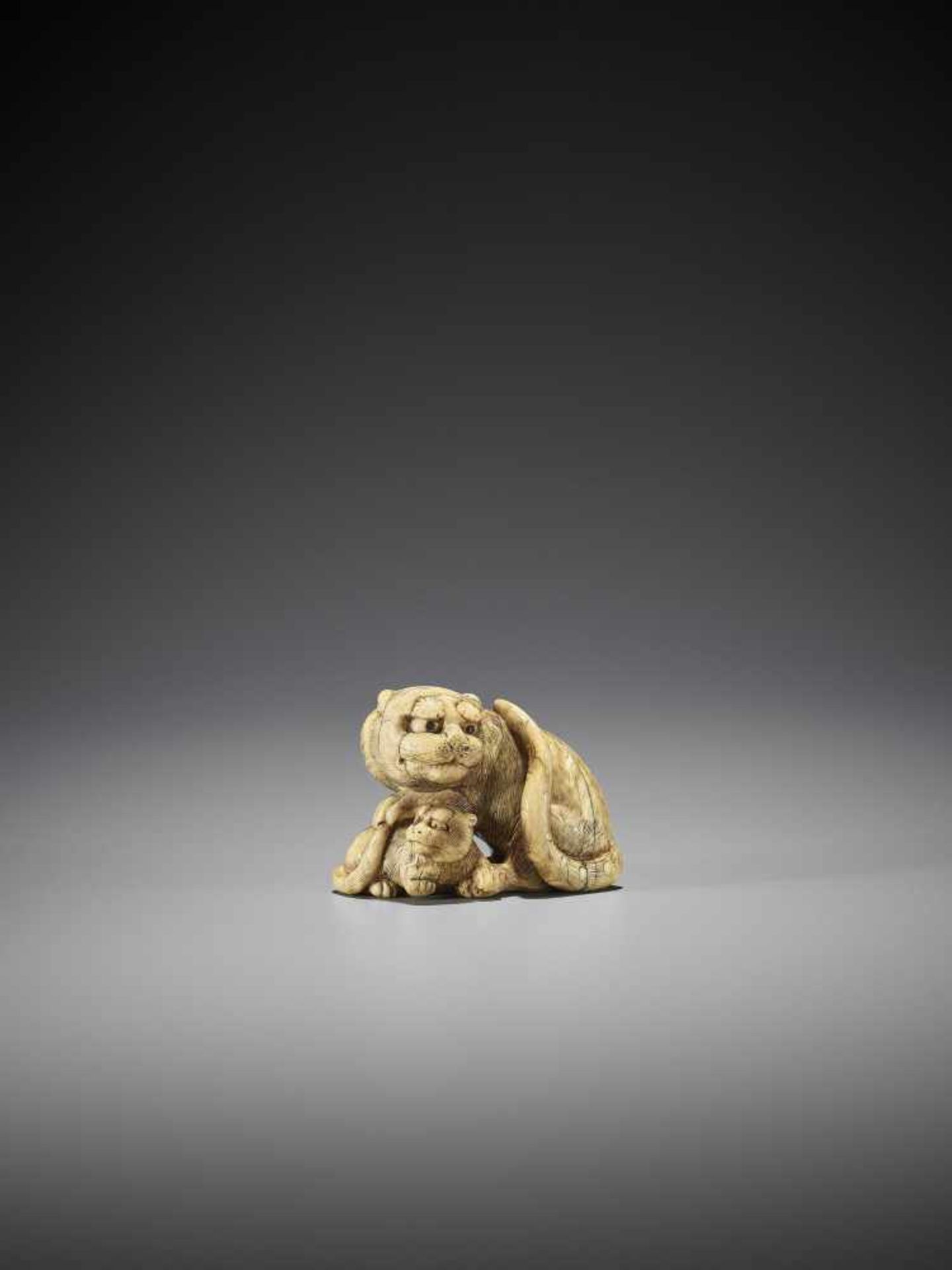 TOMOTADA: AN IVORY NETSUKE OF A TIGER AND CUB