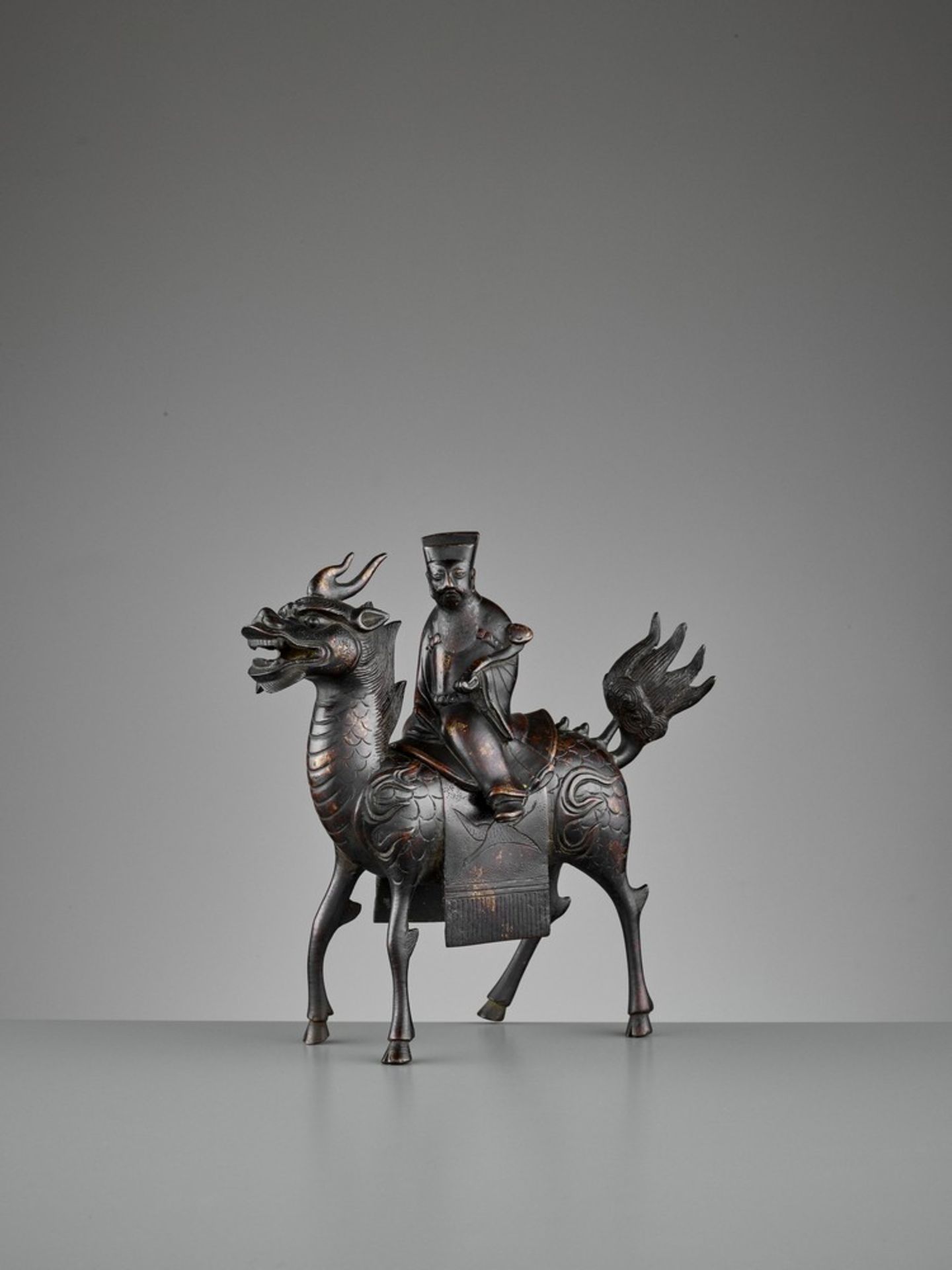 A ‘QILIN AND DIGNITARY’ BRONZE CENSER, QING <br