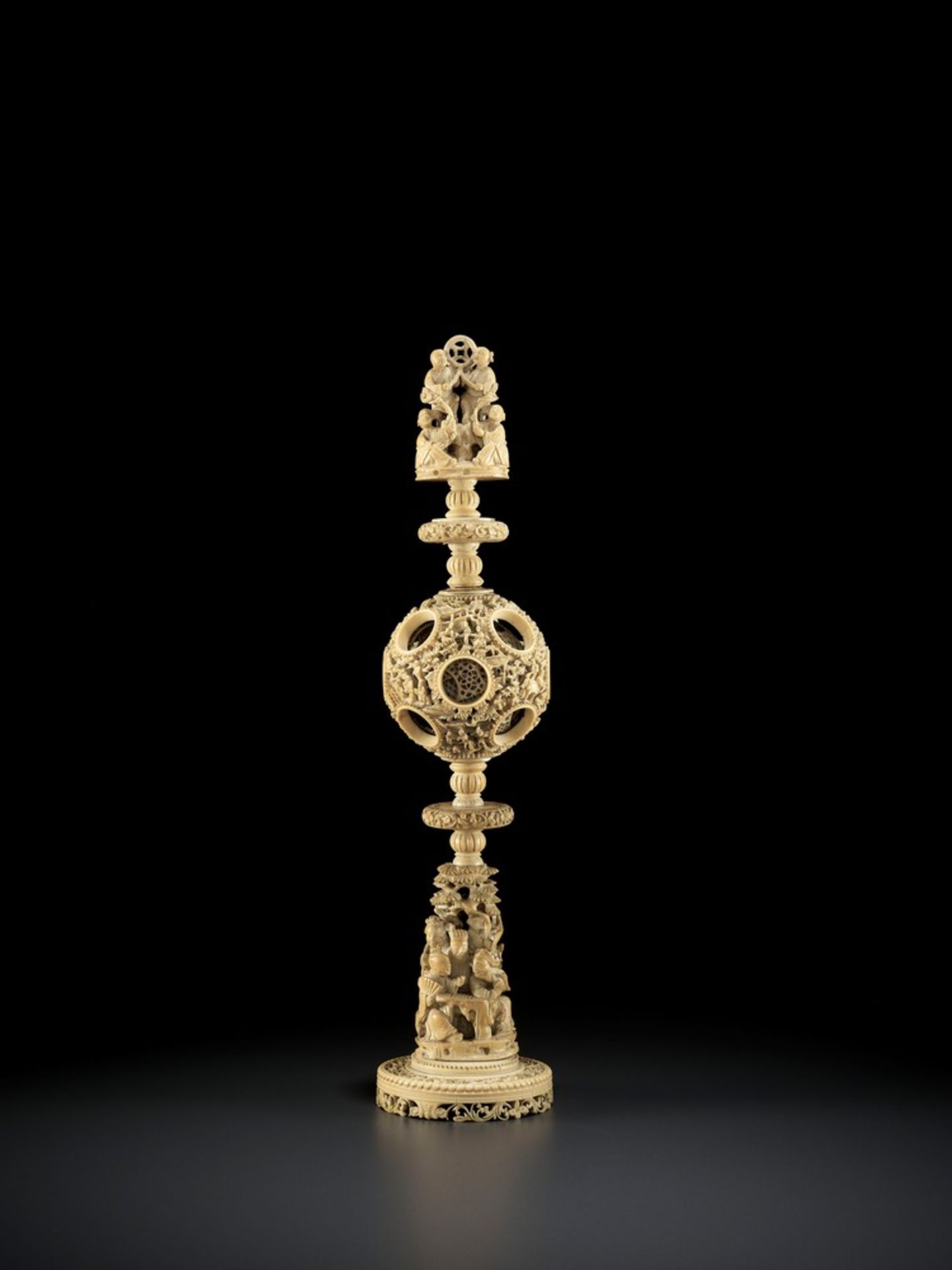A CANTON SCHOOL 'MAGIC' IVORY BALL ON A TALL STAND, QING DYNASTY