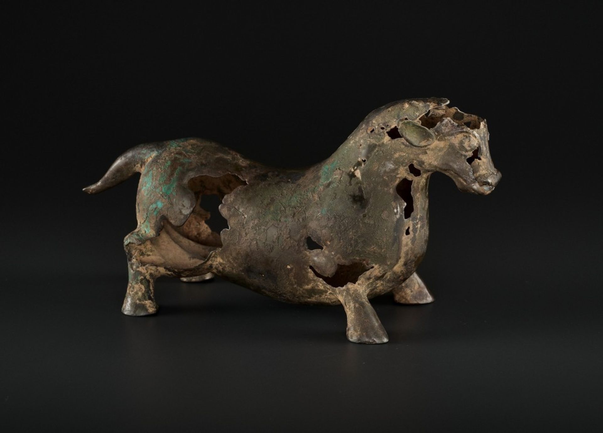 A SUPERB BRONZE FIGURE OF A BULL, LATE WARRING STATES TO EARLY HAN DYNASTY