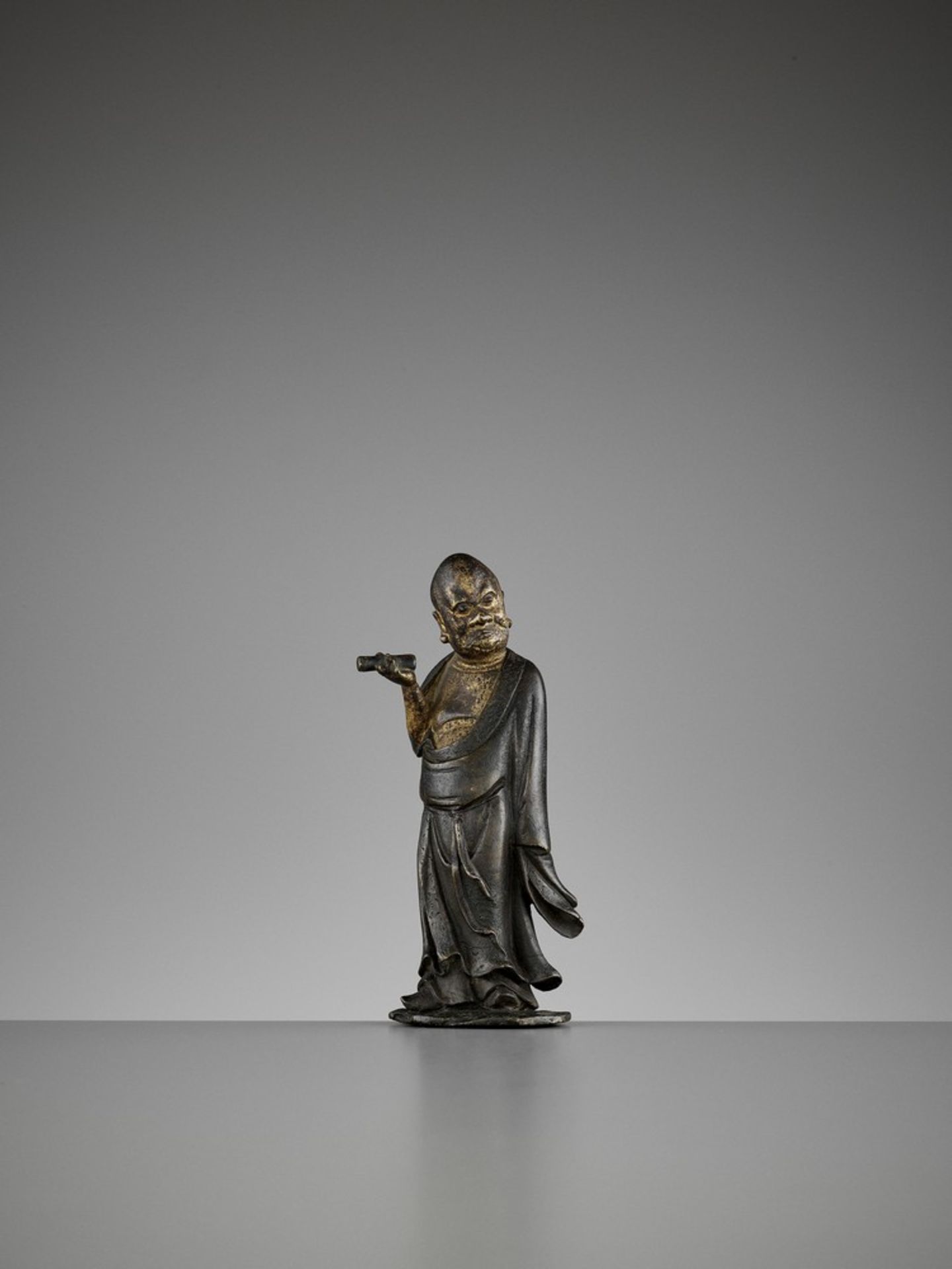 A LACQUER-GILT BRONZE FIGURE OF A LUOHAN, MING