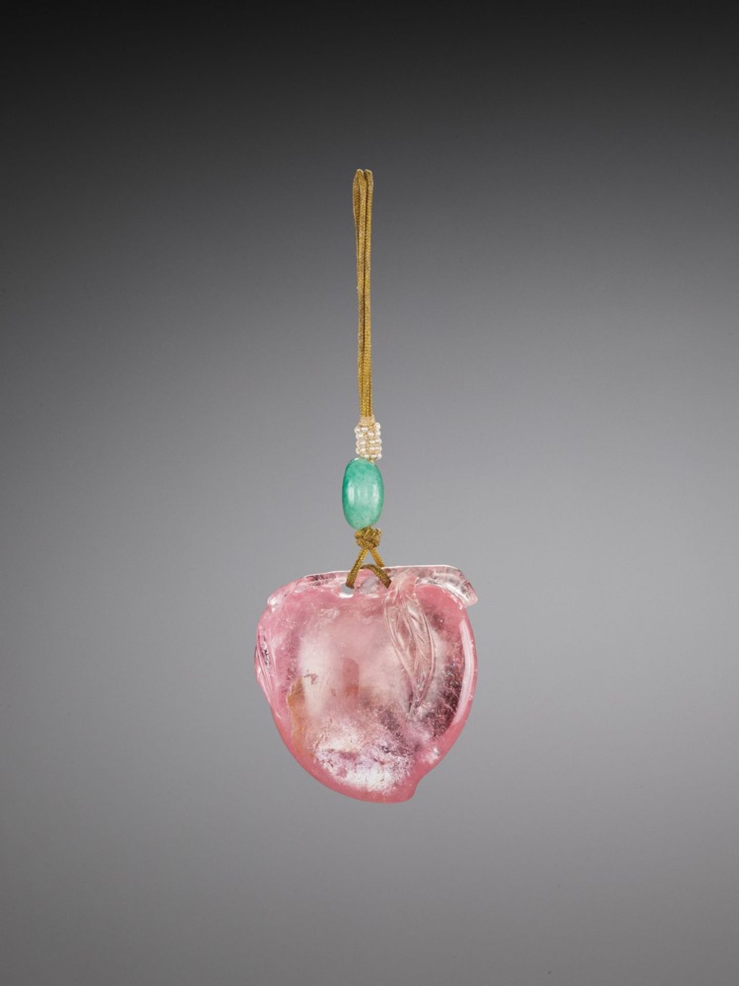 A CARVED PINK TOURMALINE 'PEACH' PENDANT, QING DYNASTY