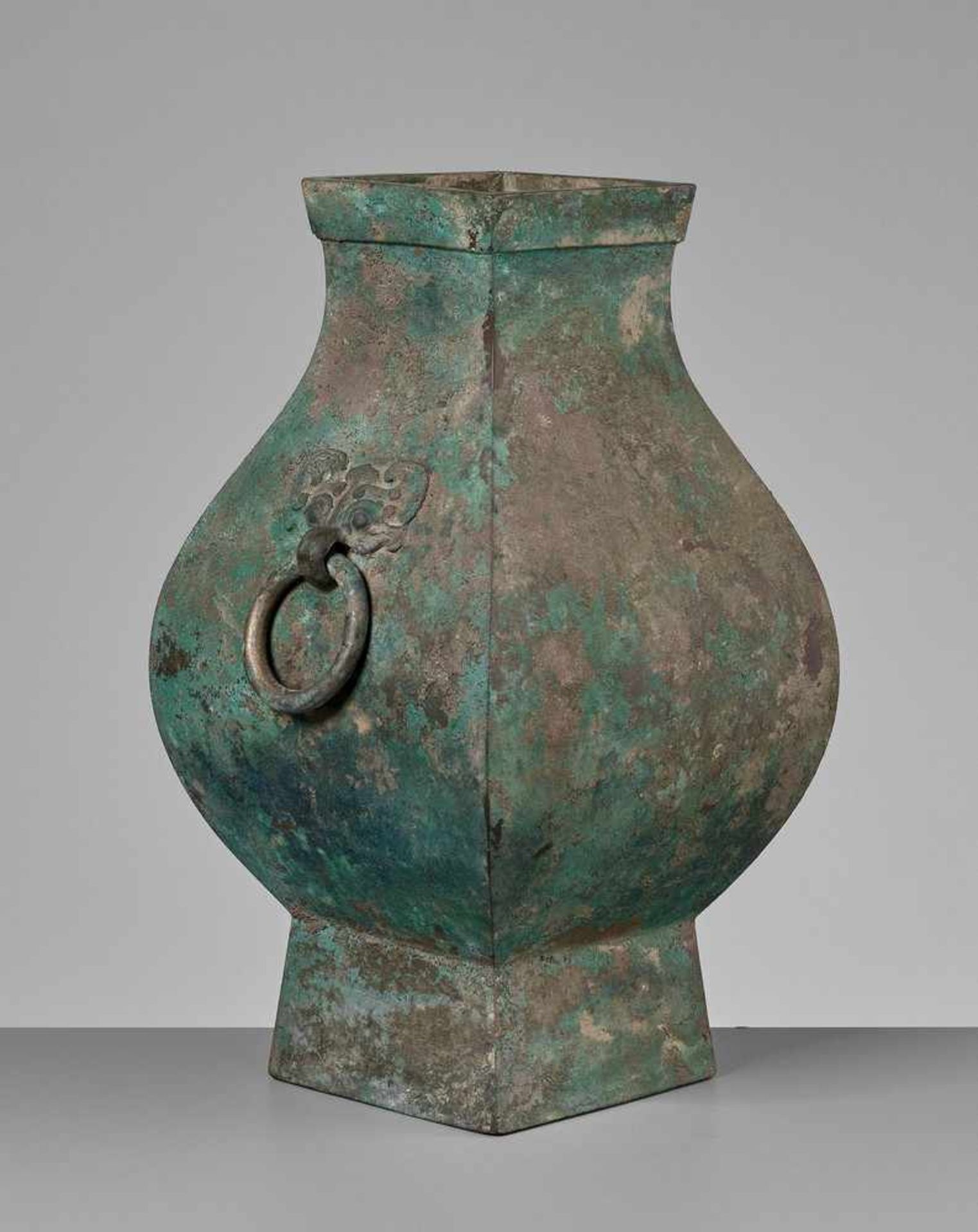 A FACETED BRONZE STORAGE VESSEL, FANGHU, HAN DYNASTY China, 206 BC-AD 220. The faceted pear-shaped