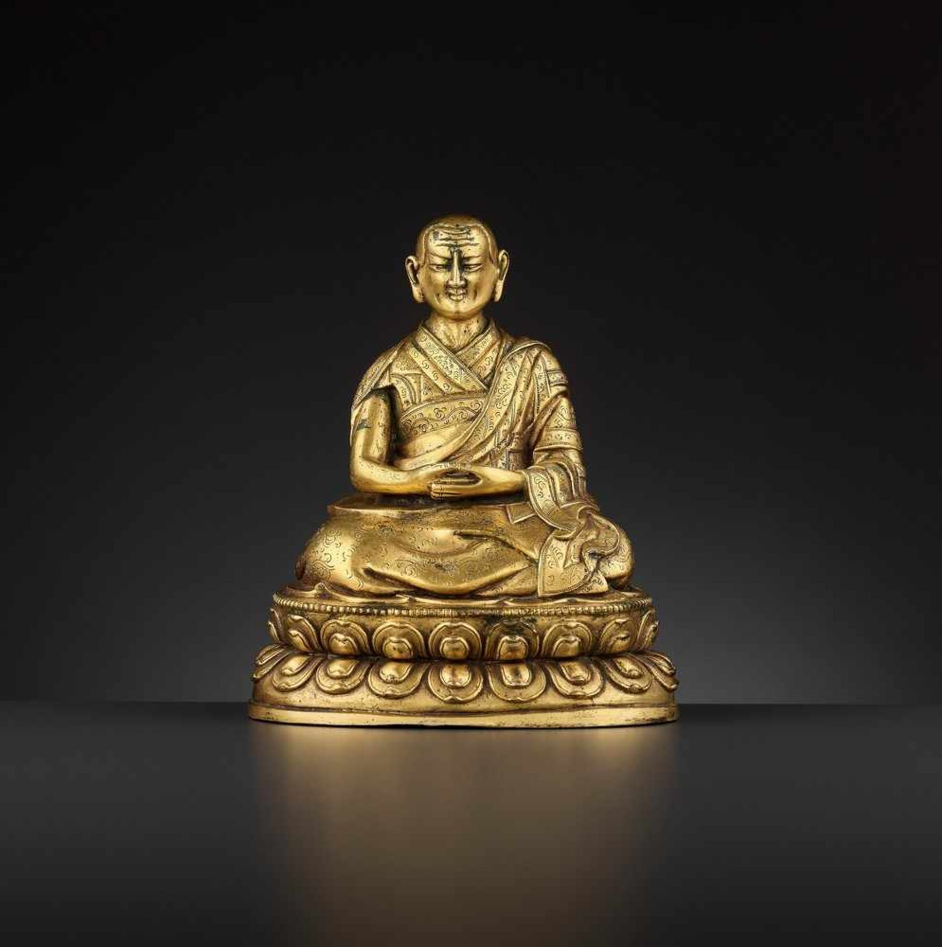 A GILT BRONZE OF THE FIFTH PANCHEN LAMA, TIBET, LATE 17TH TO EARLY 18TH CENTURY