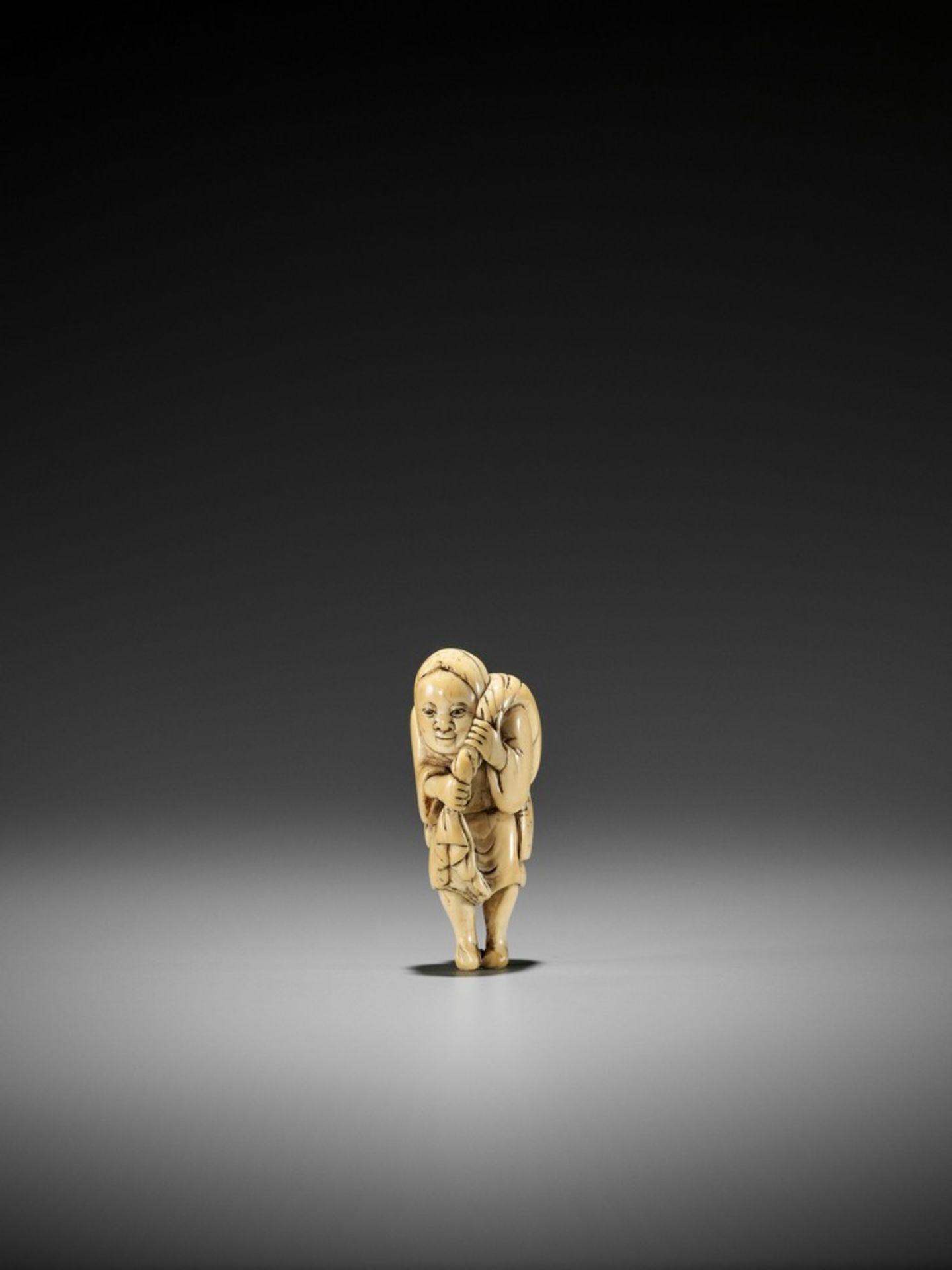 YOSHINAGA: A SUPERB AND RARE IVORY NETSUKE OF A BUCKET SELLER By Yoshinaga, signed Yoshinaga