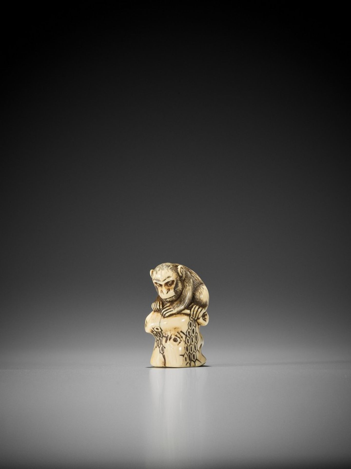 SEIMIKEN: AN IVORY NETSUKE OF A MONKEY ON TOP OF A BEEHIVE Signed Seimiken 青未軒Japan, early 19th
