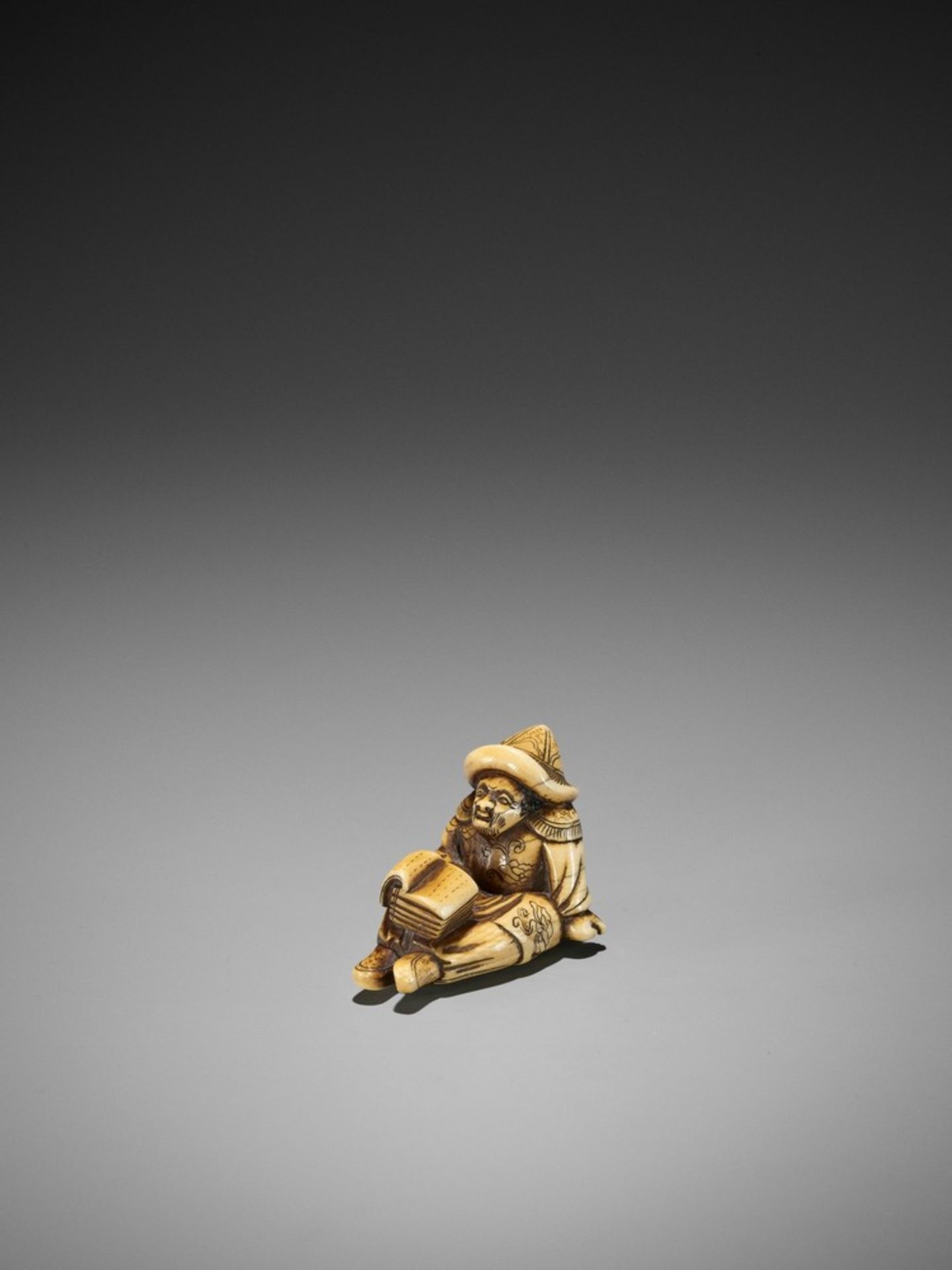 A RARE AND EARLY IVORY NETSUKE OF A SEATED DUTCHMAN READING UnsignedJapan, 18th century, Edo