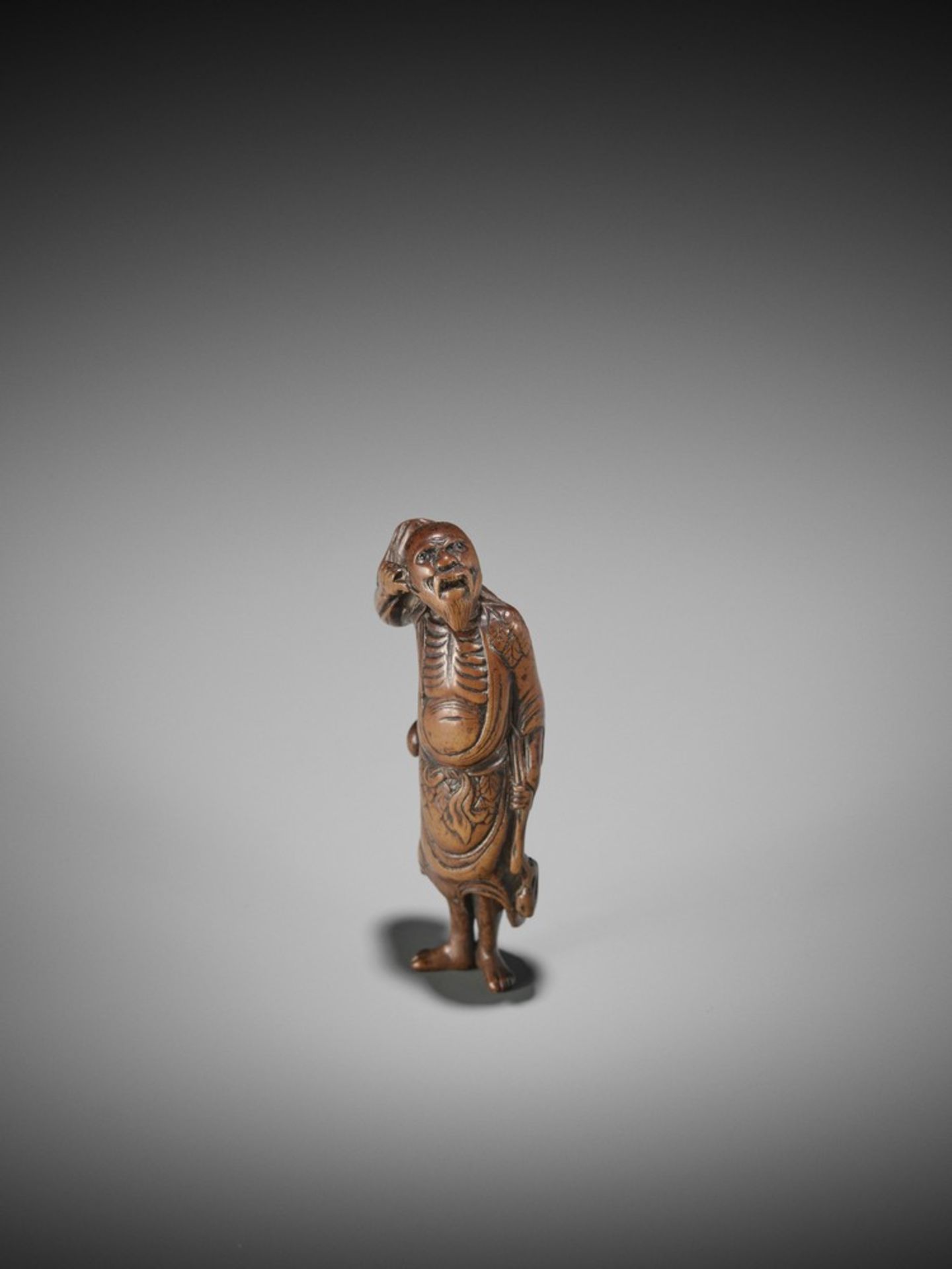 A WOOD NETSUKE OF TEKKAI SENNIN UnsignedJapan, 18th century, Edo period (1615-1868)A spirited old