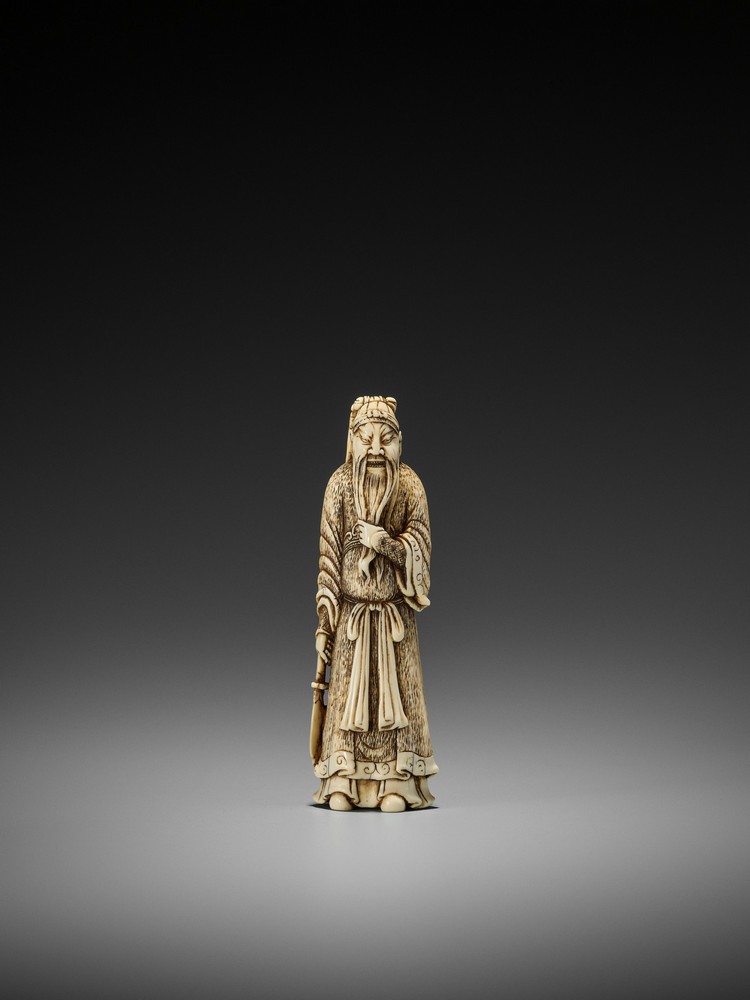 A LARGE IVORY NETSUKE OF KAN’U UnsignedJapan, late 18th century, Edo period (1615-1868)The god of