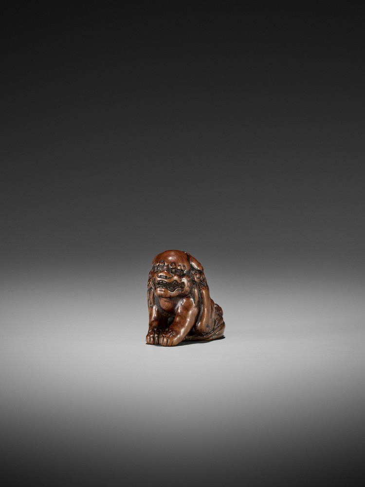 A WOOD NETSUKE OF A SHISHI ATTRIBUTED TO CHIKUYOSAI TOMOCHIKA I Attributed to Chikuyosai Tomochika