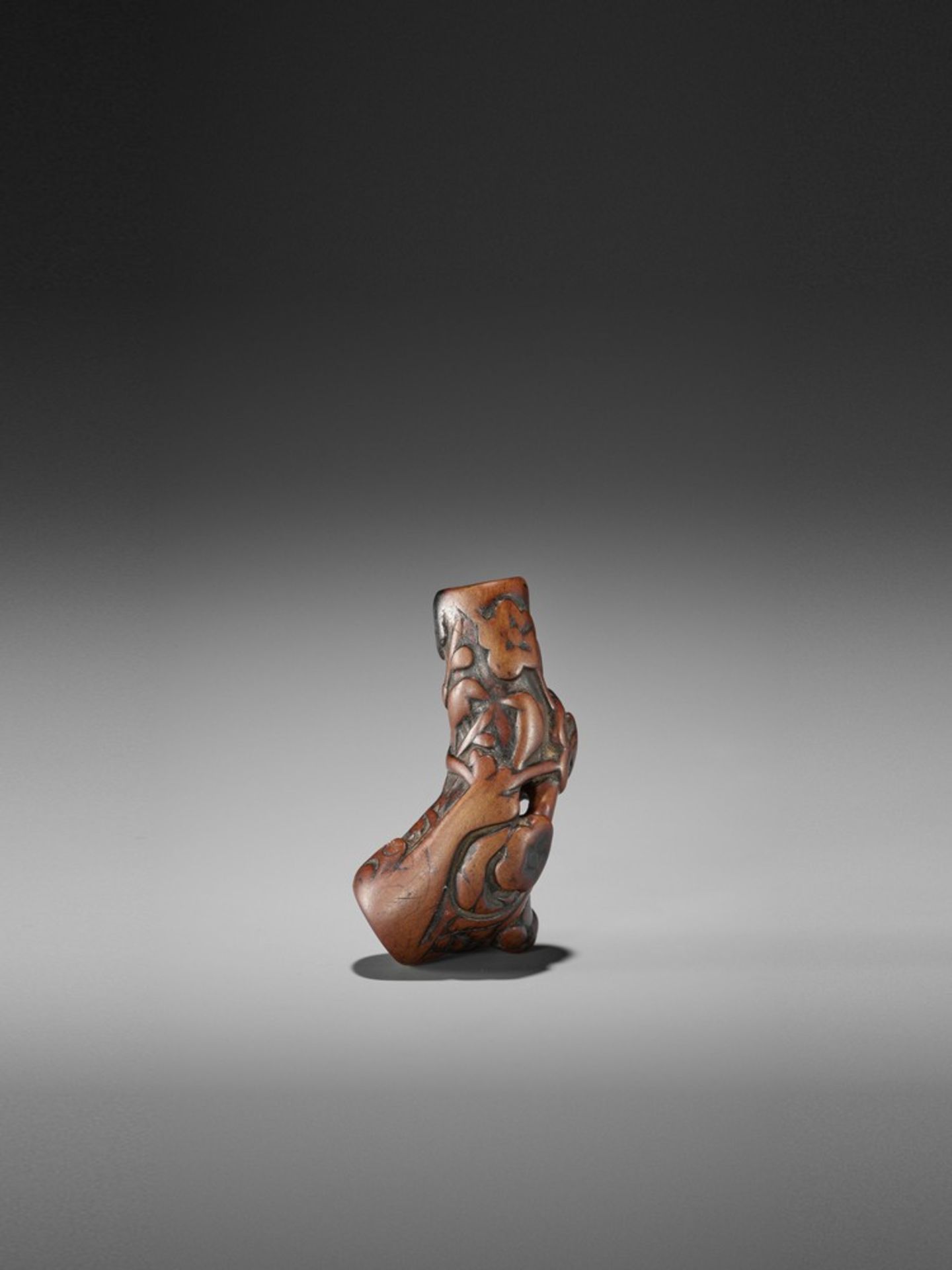 AN OLD WORN WOOD NETSUKE OF BIRDS AND MONKEYS IN A PLUM TREE UnsignedJapan, 18th century, Edo period