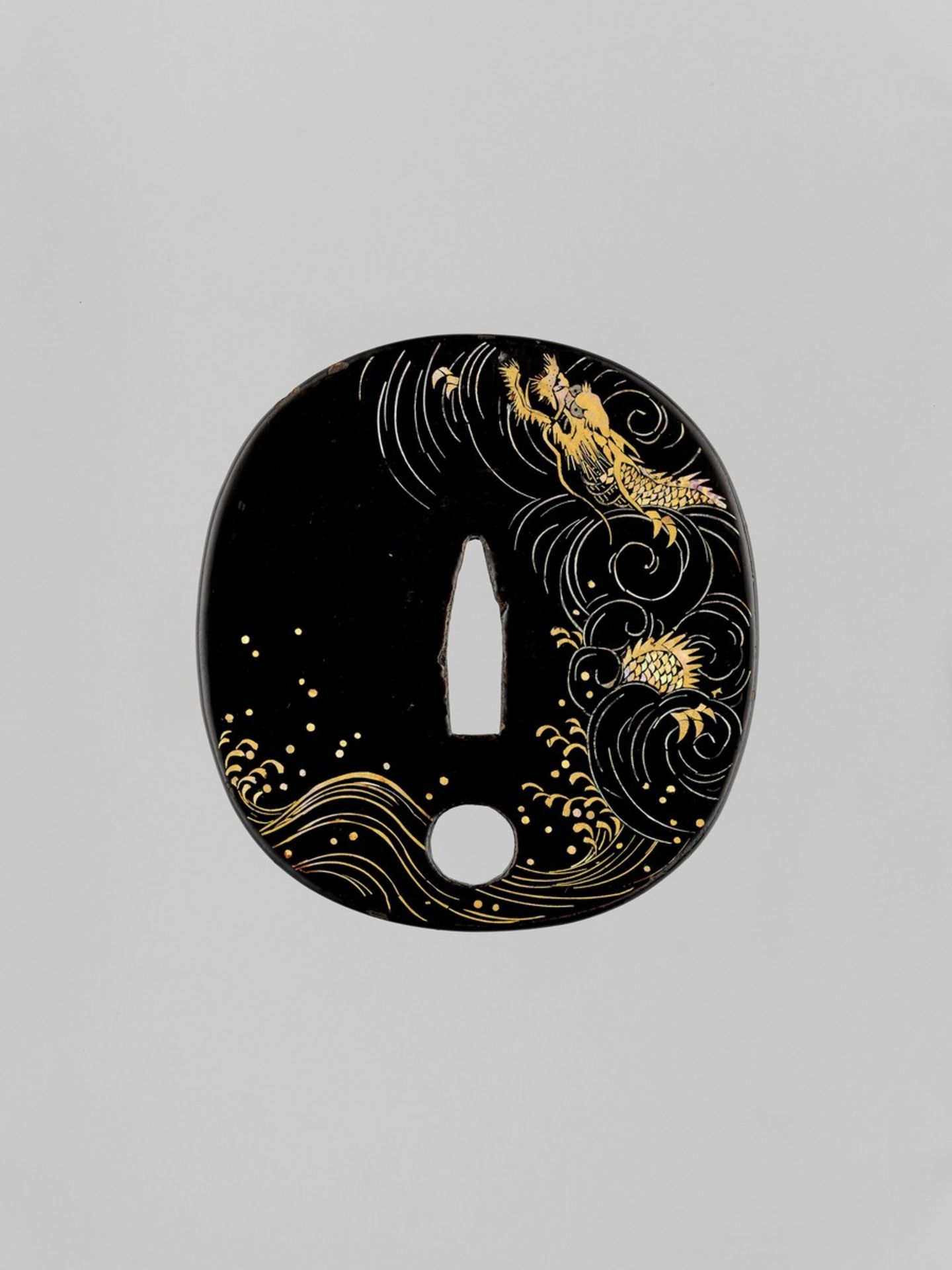 A RARE LACQUERED AND INLAID IRON TSUBA WITH DRAGON Japan, 19th century, Edo period (1615-1868)The