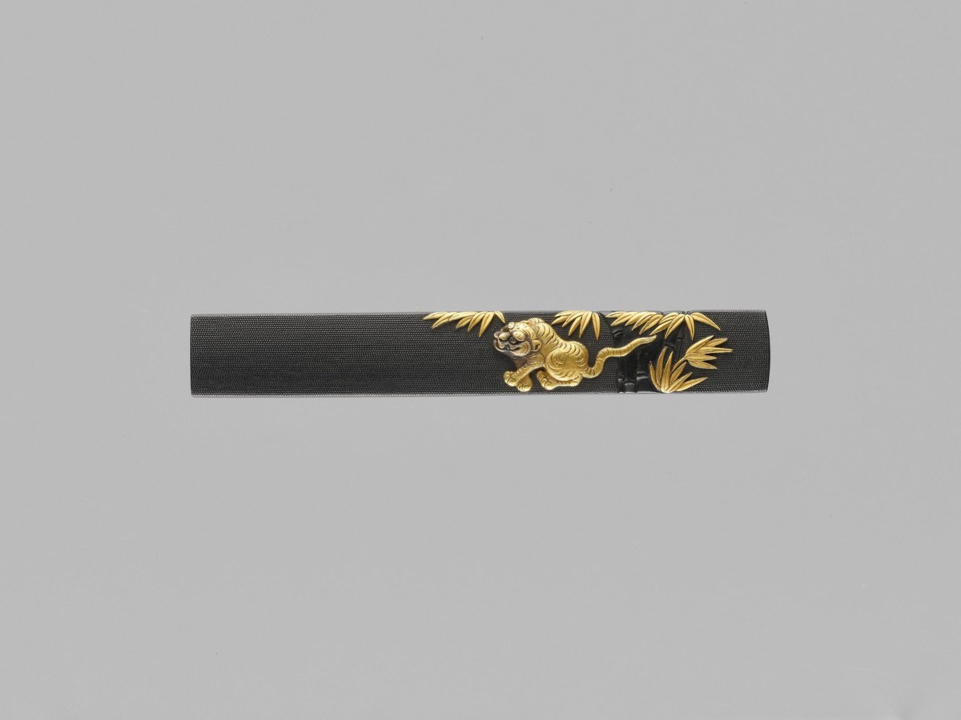 HOYUSAI NAOTSUNE: A MASTERFUL GOTO SCHOOL KOZUKA WITH TIGER AND BAMBOO By Hoyusai Naotsune, signed