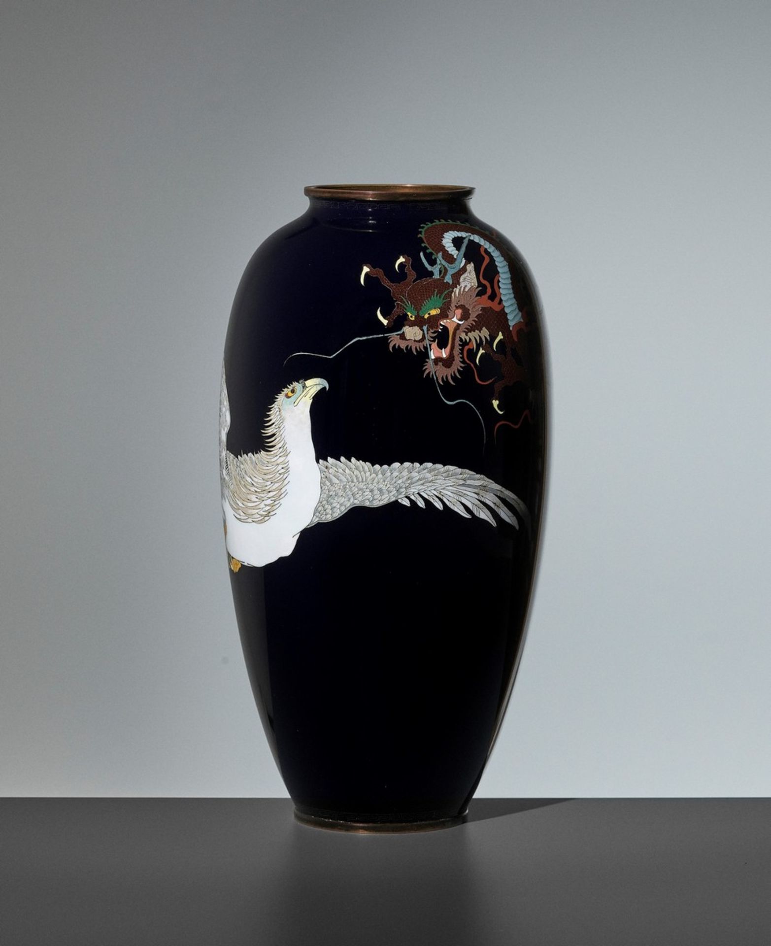 A LARGE CLOISONNÉ VASE WITH CONFRONTING HAWK AND DRAGON Japan, Meiji period (1868-1912)The large