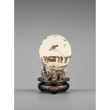 A RARE LACQUERED OSTRICH EGG DEPICTING A PROCESSION OF FROGS Japan, Meiji period (1868-1912)Set on a