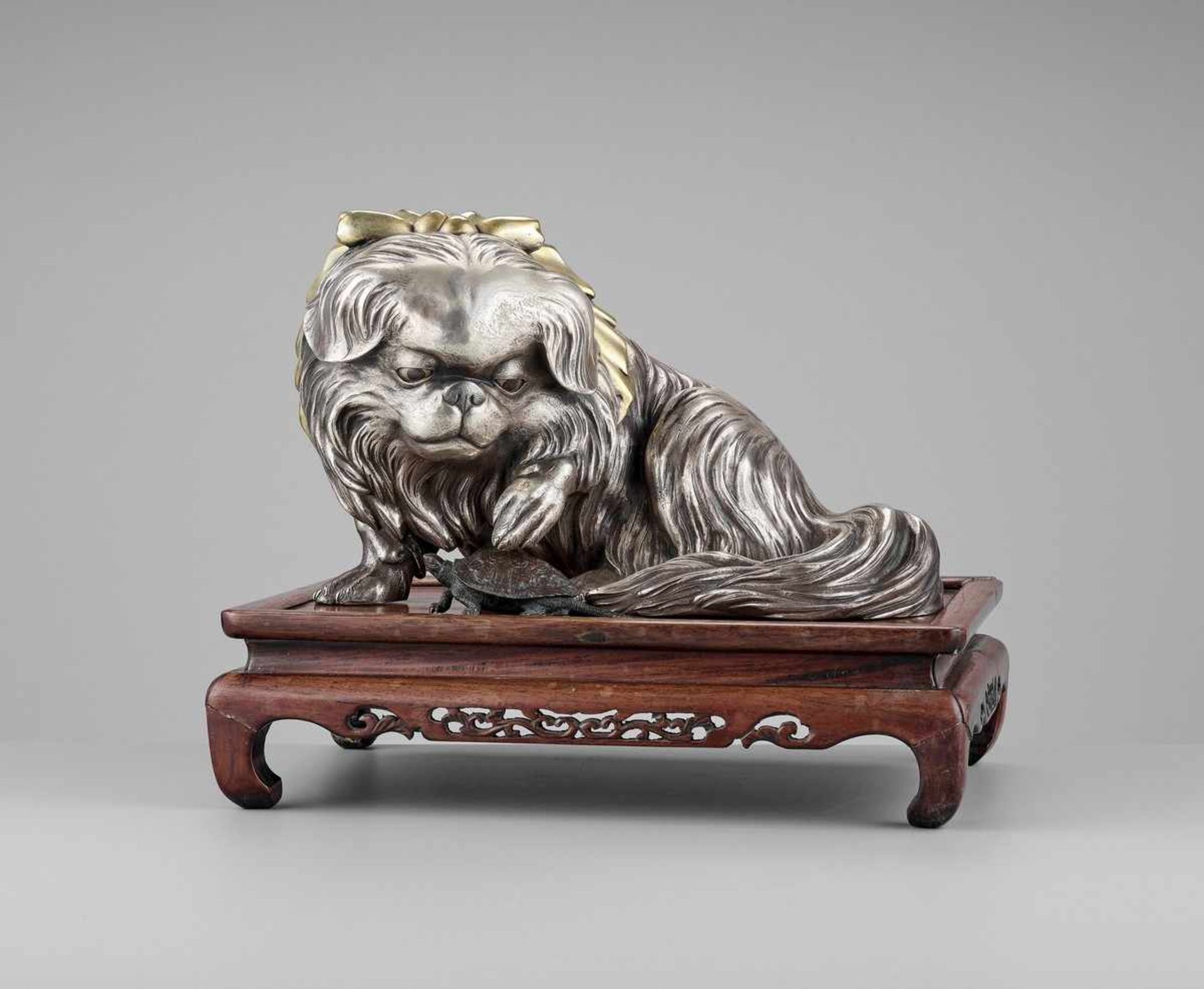 MARUKI COMPANY: AN EXCEPTIONAL AND LARGE PARCEL-GILT AND SILVERED OKIMONO OF A CHIN DOG By the