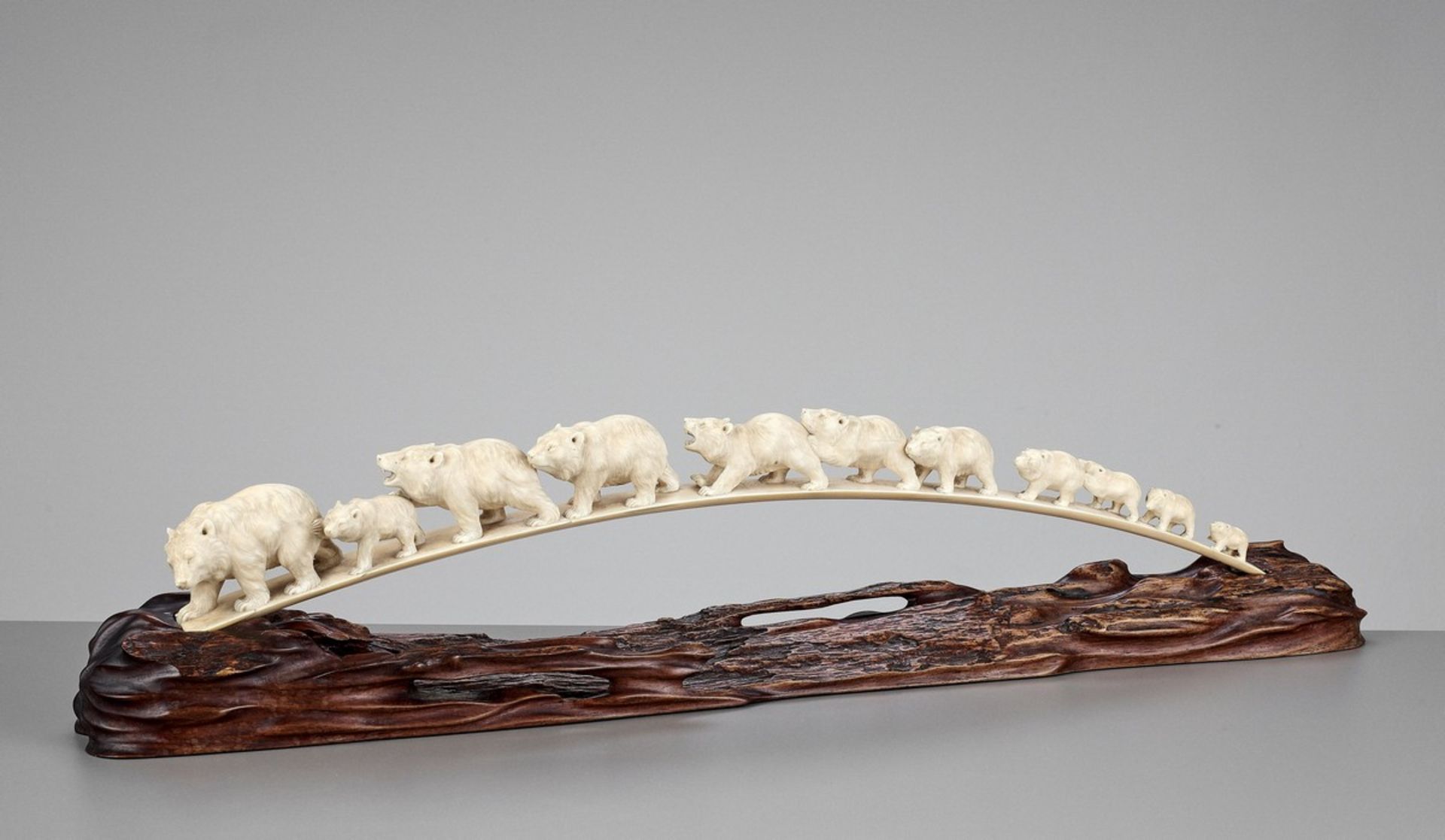 AN IVORY TUSK OKIMONO OF TRAVELING BEARS Japan, Meiji period (1868-1912)Finely carved with a group