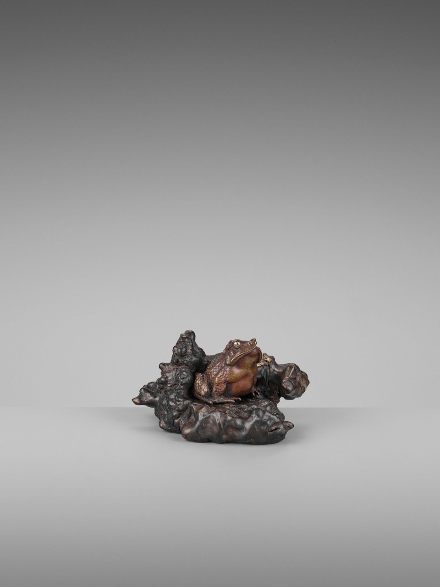 A FINE PARCEL-GILT BRONZE AND ROOT WOOD OKIMONO OF A TOAD Japan, Meiji period (1868-1912)The toad