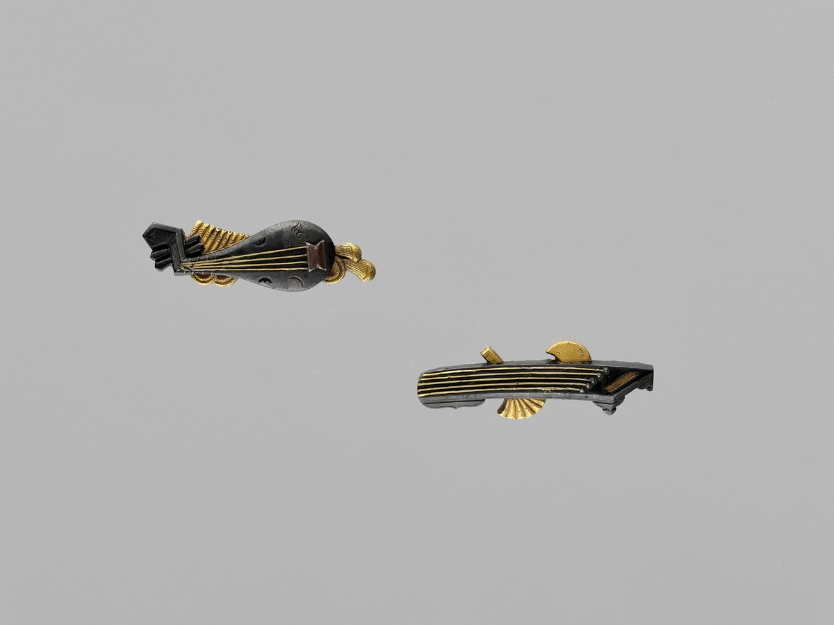 A FINE PAIR OF MENUKI DEPICTING MUSICAL INSTRUMENTS Japan, 19th century, Edo period (1615-1868)Of