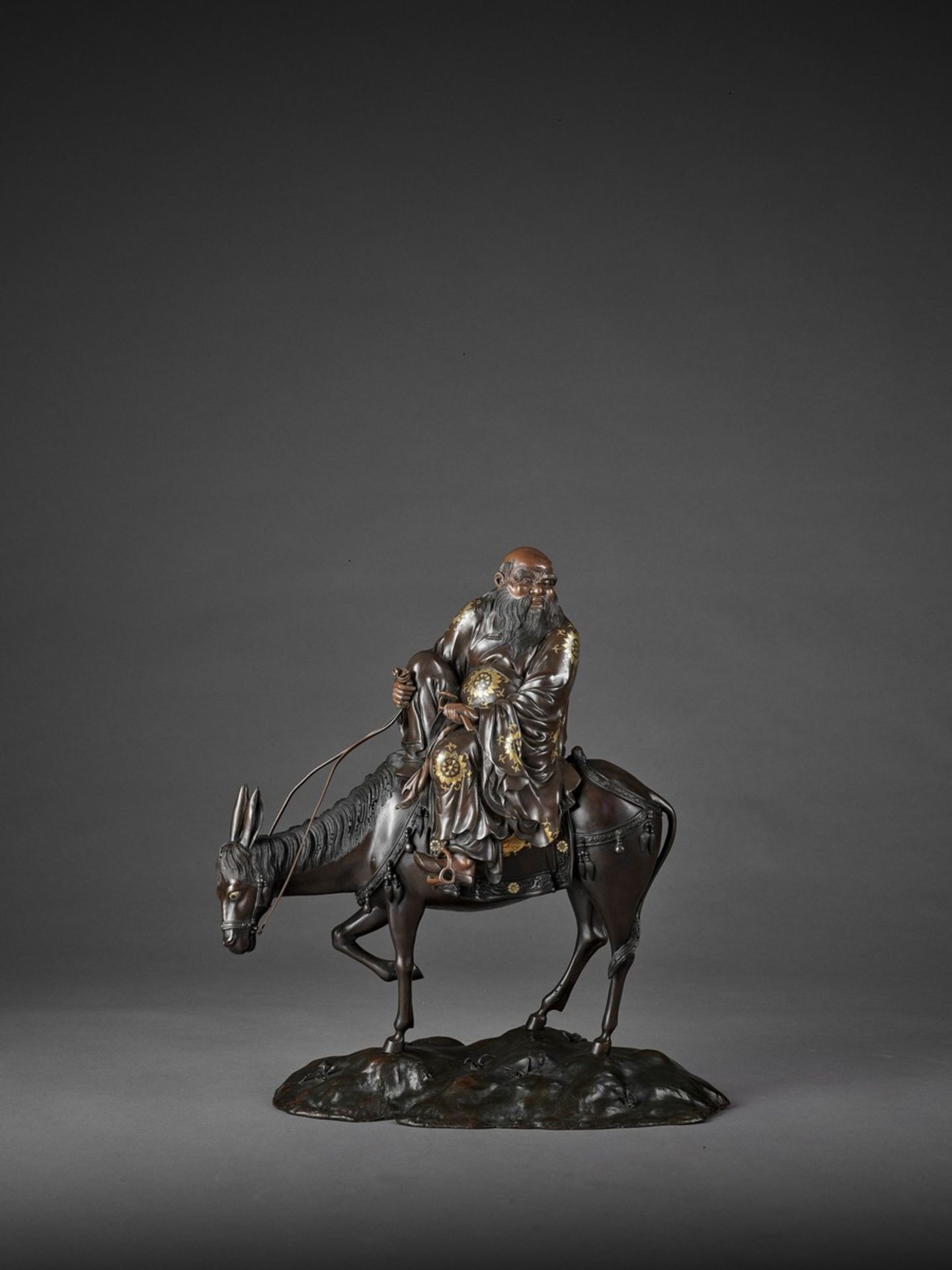 A SPECTACULAR AND MASSIVE PARCEL GILT BRONZE FIGURE OF TOBA SEATED ON A MULE Attributed to the Miyao - Image 3 of 12