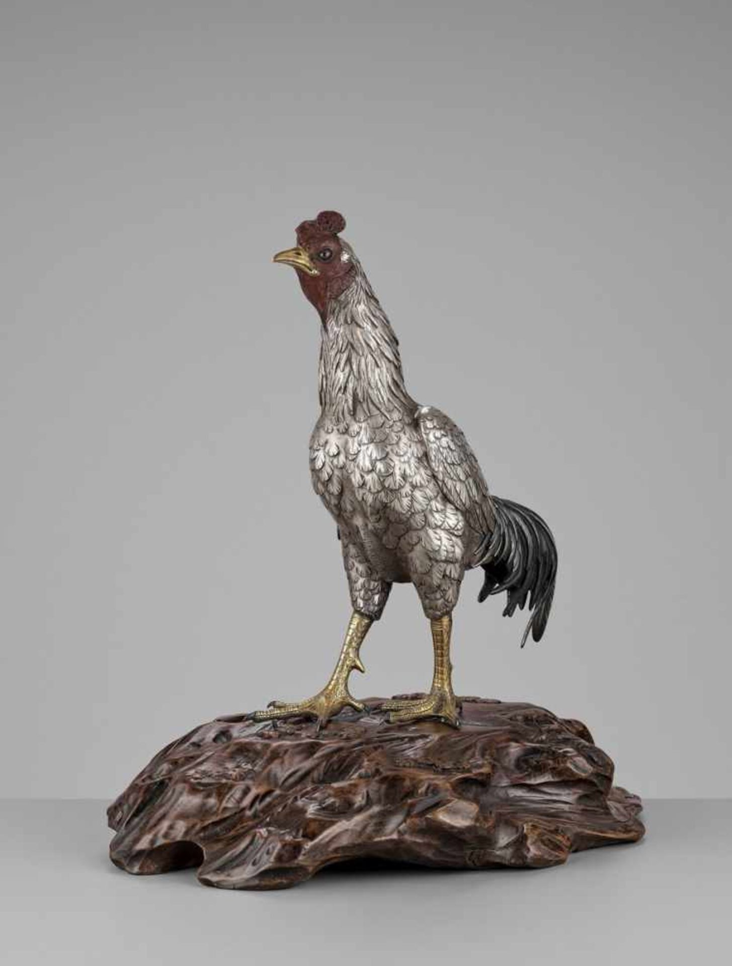 SEIYA: AN UNUSUAL AND RARE PARCEL-GILT SILVERED BRONZE OKIMONO OF A COCKEREL By Genryusai Seiya,