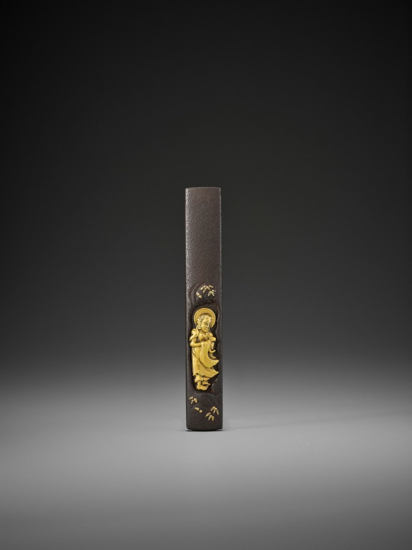 A SUPERB IRON AND GOLD KOZUKA WITH BUDDHA SHAKYAMUNI Japan, 18th to 19th century, Edo period (1615-