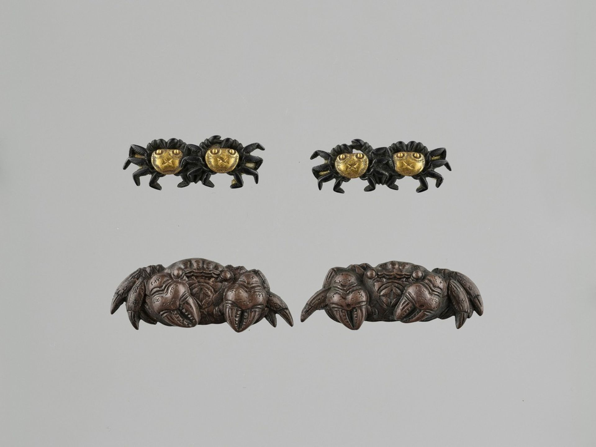 TWO MATCHING PAIRS OF MENUKI DEPICTING CRABS Japan, 19th century, Edo period (1615-1868)The first