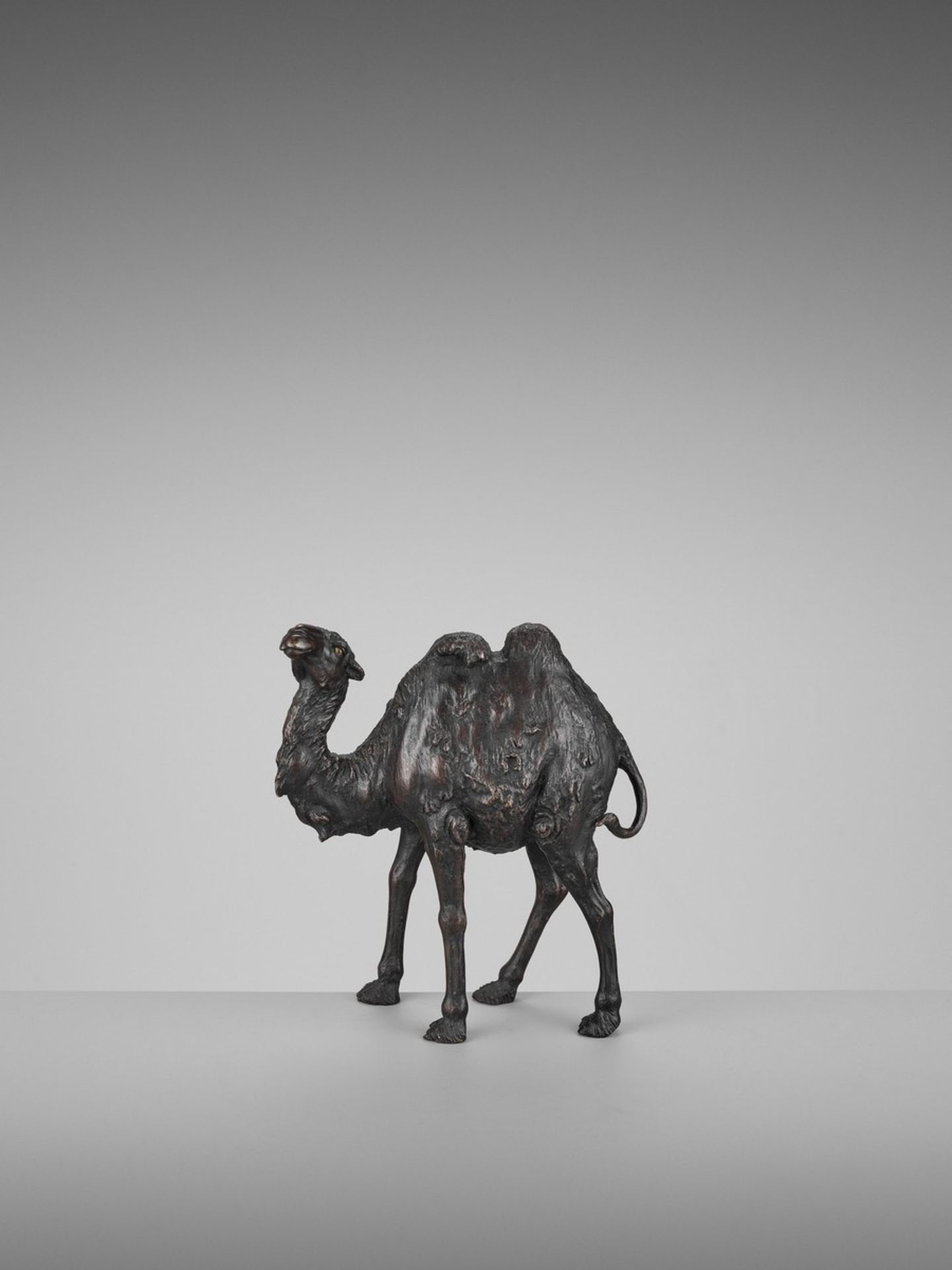 GENRYUSAI SEIYA: A RARE PATINATED BRONZE OKIMONO OF A BACTRIAN CAMEL By Genryusai Seiya, signed