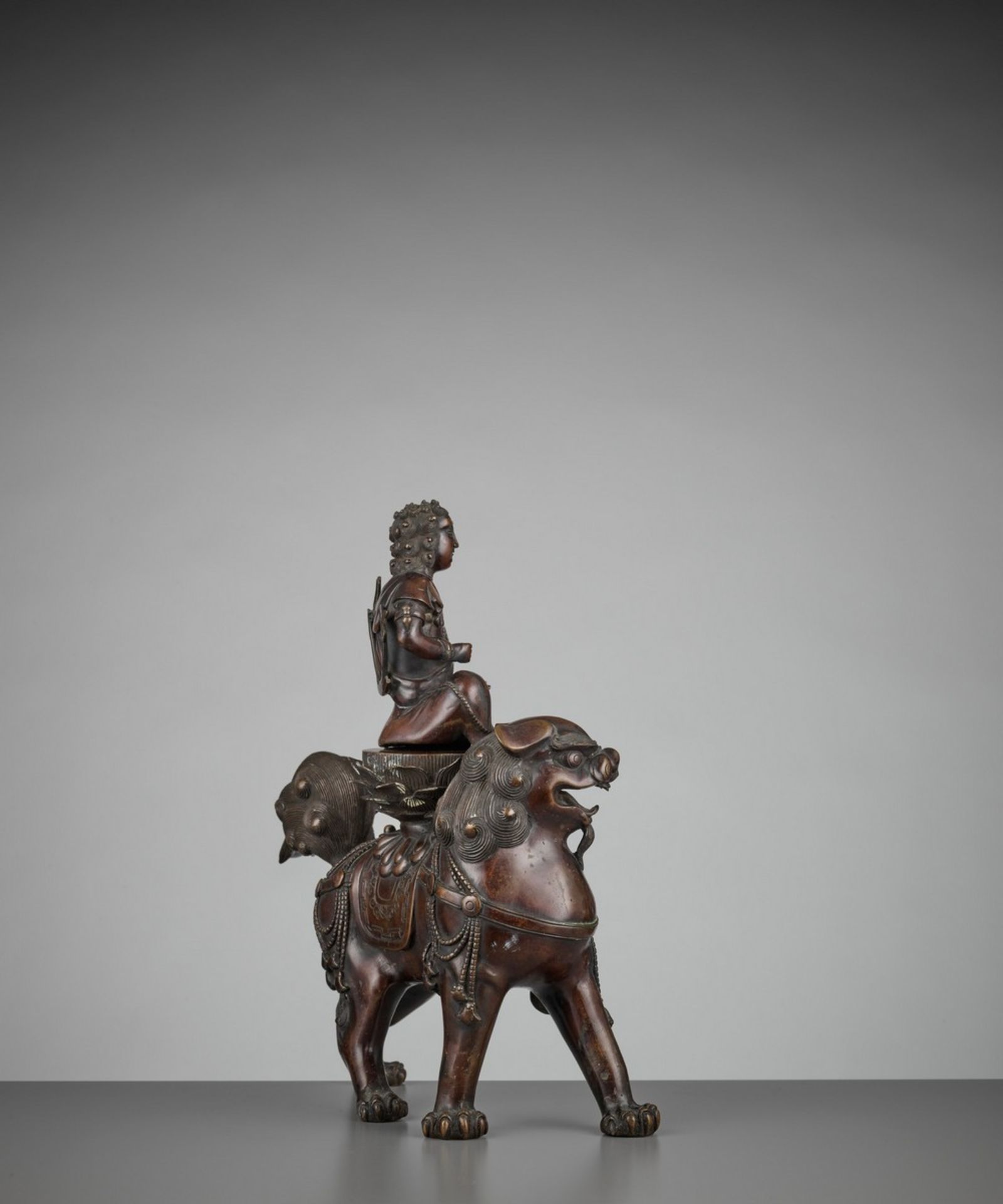 A BRONZE GROUP OF KISHI MONJU BOSATSU RIDING A SHISHI Japan, 18th century, Edo period (1615-1868) - Image 8 of 13