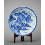 A MONUMENTAL ARITA PORCELAIN CHARGER WITH A MOUNTAIN LANDSCAPE Japan, first half of 20th centuryThis