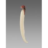 A DECORATIVE IVORY DAGGER WITH A LONG-TAILED PARROT Japan, Meiji period (1868-1912)The blunt