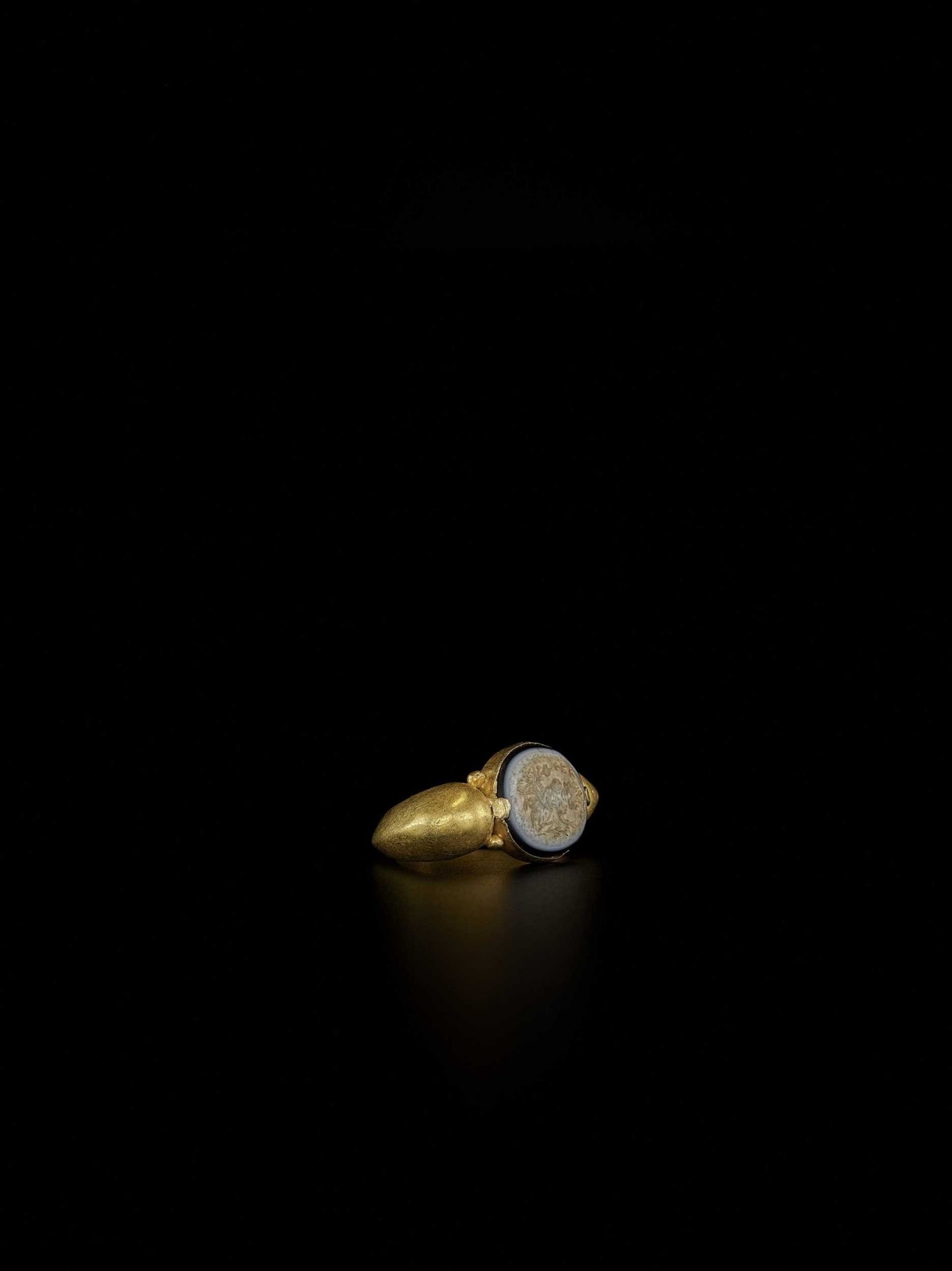 A PYU GOLD RING WITH EYE AGATE INTAGLIO