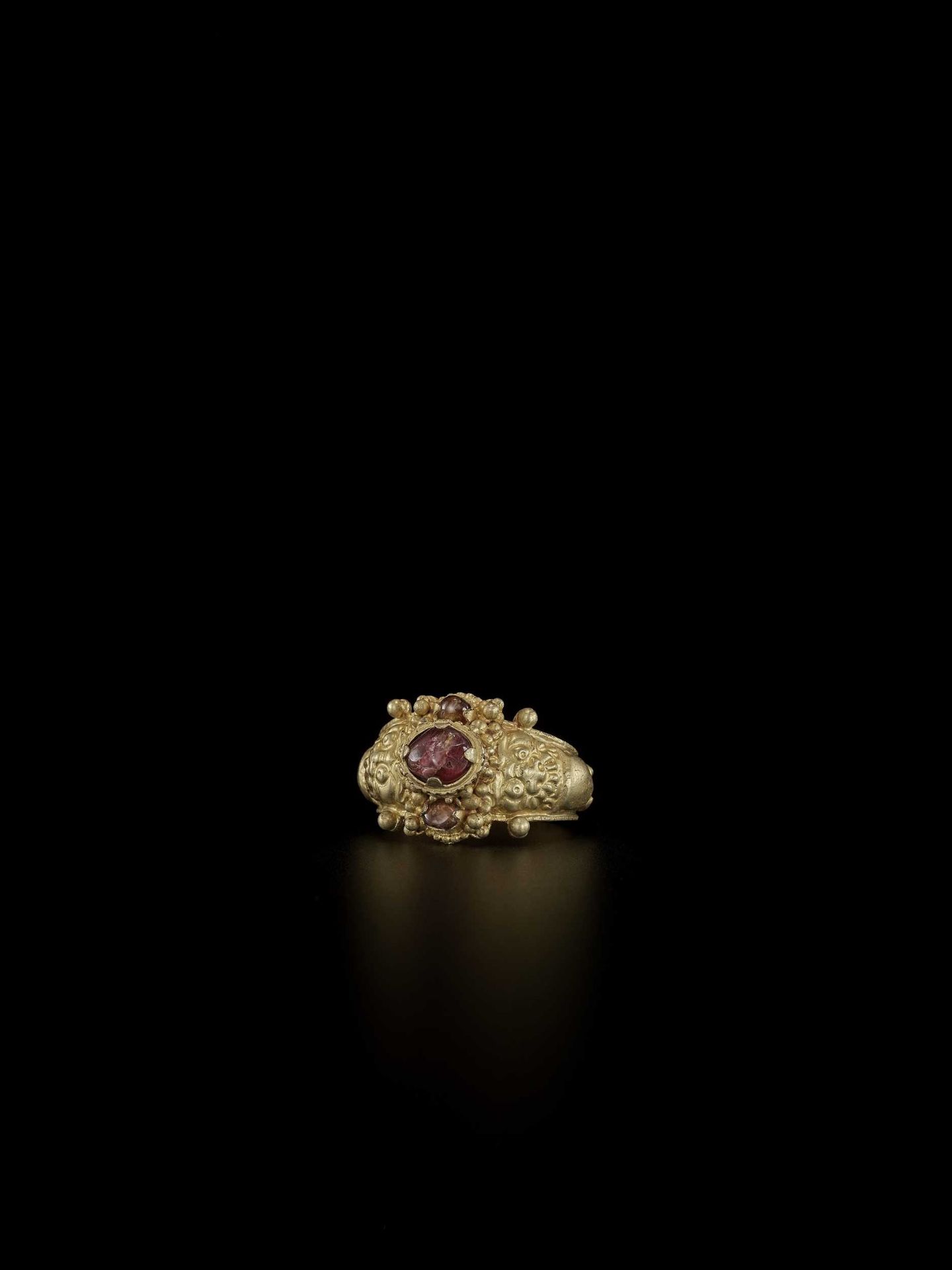 A CHAM AMETHYST AND CRYSTAL-SET GOLD REPOUSSÉ RING WITH KALA MASKS