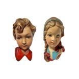 Couple faces of Swedish kids in terracotta. XX century. 25 Cm.