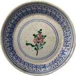 Majolica plate of Caltagirone, Sicily, early twentieth century. Decorated with a pink flower. First