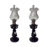 Pair of lamps in black opal, XX century. Frame gilt metal, white glass bowls. H 53 cm, 15 cm base.