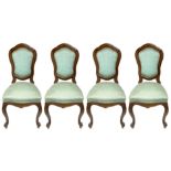 Four walnut chairs, nineteenth century. Feet curled. H 112 cm.